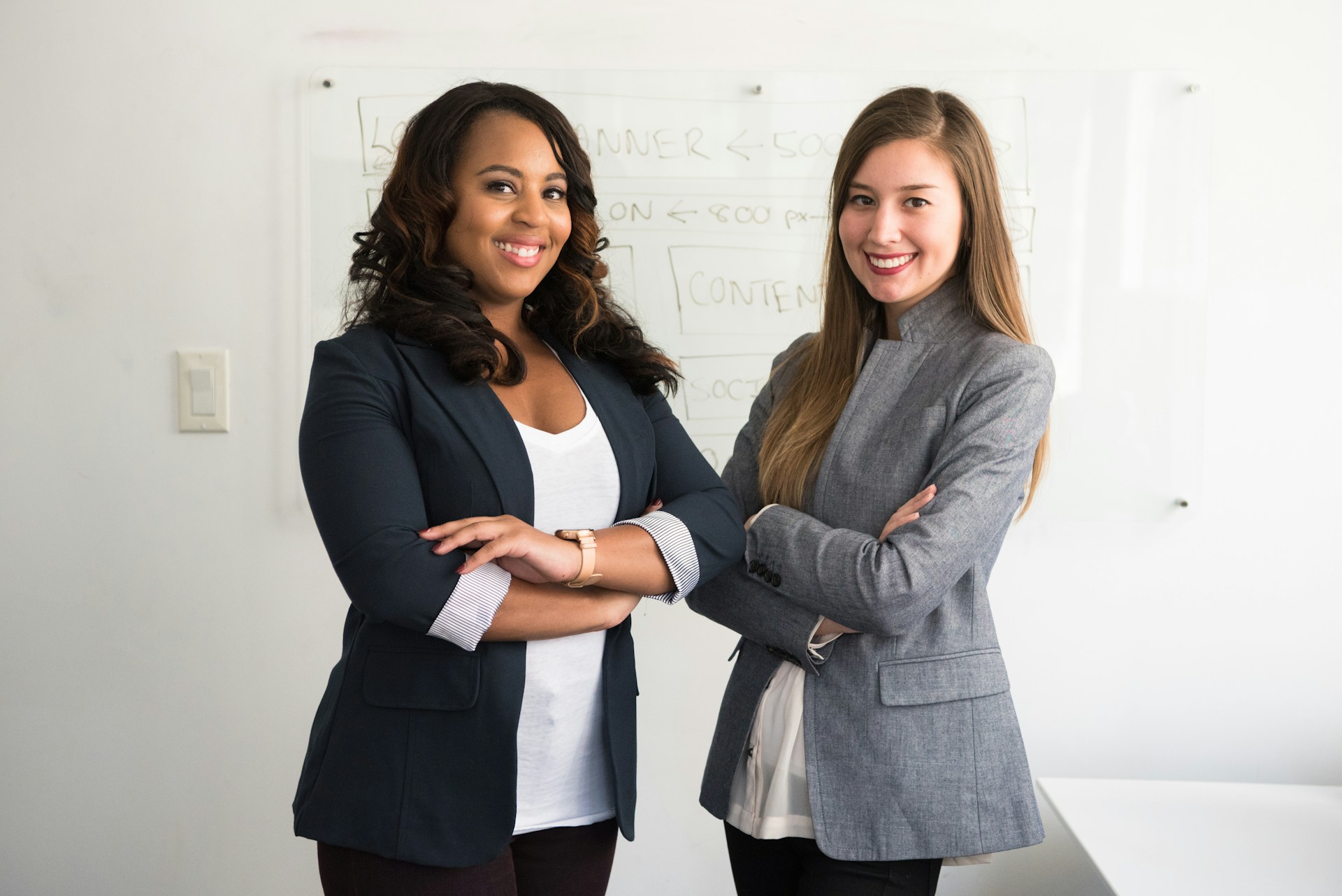 Two school counselors standing together in an office